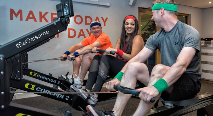 Three people on rowing machines